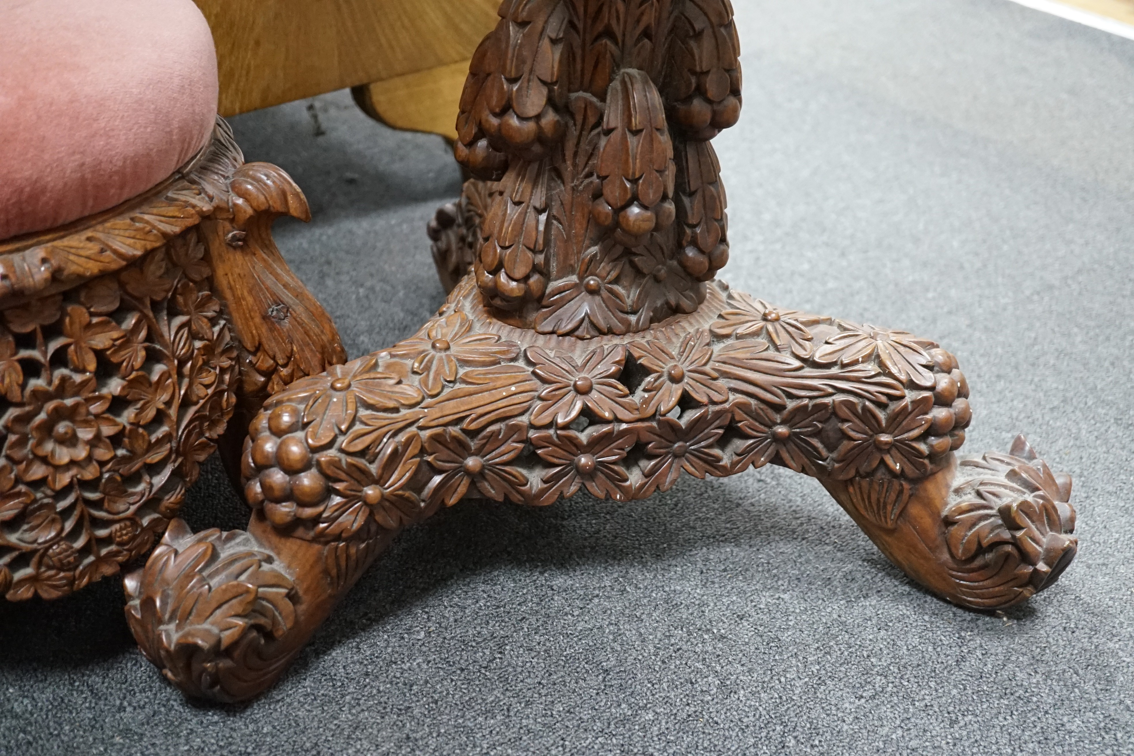 A Burmese carved hardwood circular occasional or centre table, diameter 57cm height 74cm, together with a similar side chair and foot stool